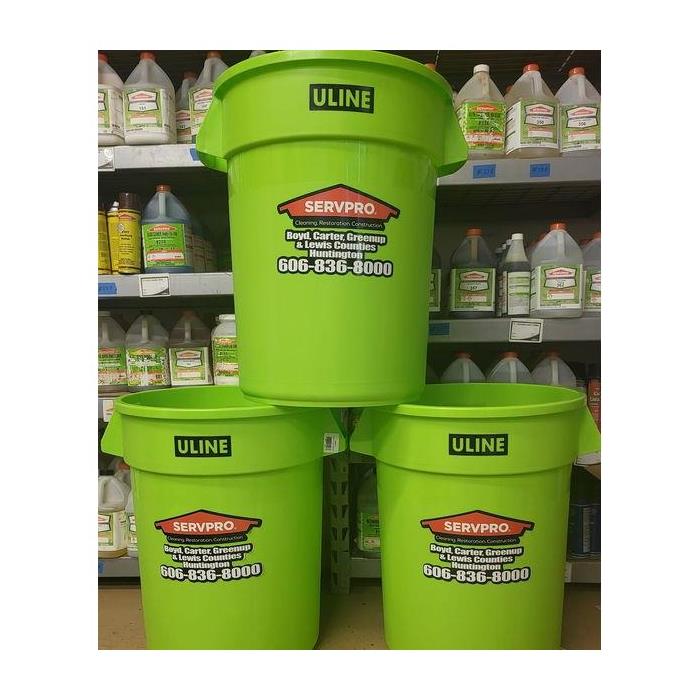 Green trash receptacles with SERVPRO logo
